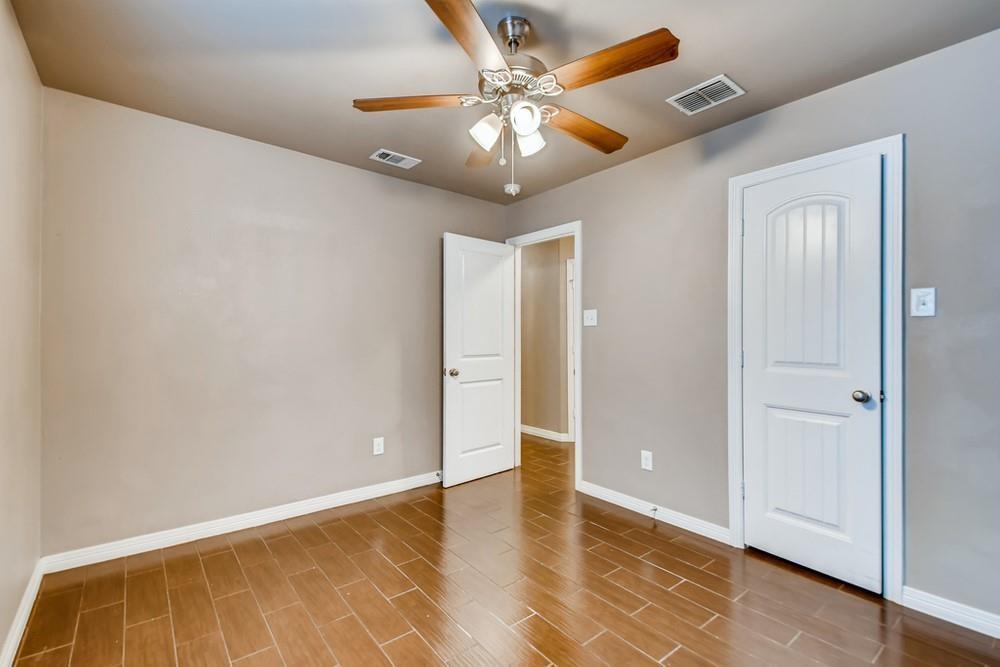 713 Rike Street McKinney, TX 75069 - Photo 22 of 29 a view of an empty room with window and wooden floor