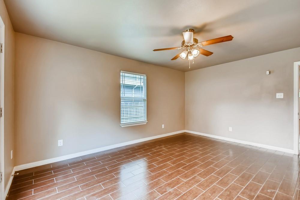 713 Rike Street McKinney, TX 75069 - Photo 23 of 29 a view of an empty room with window and chandelier fan
