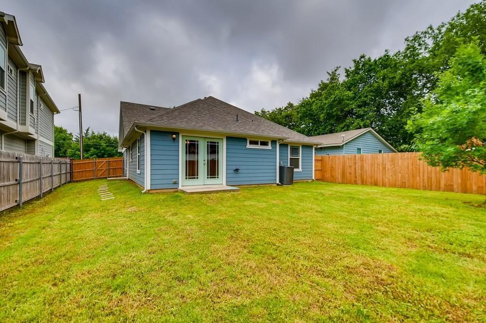 713 Rike Street McKinney, TX 75069 - Photo 4 of 29 a view of a house with a yard and a large tree