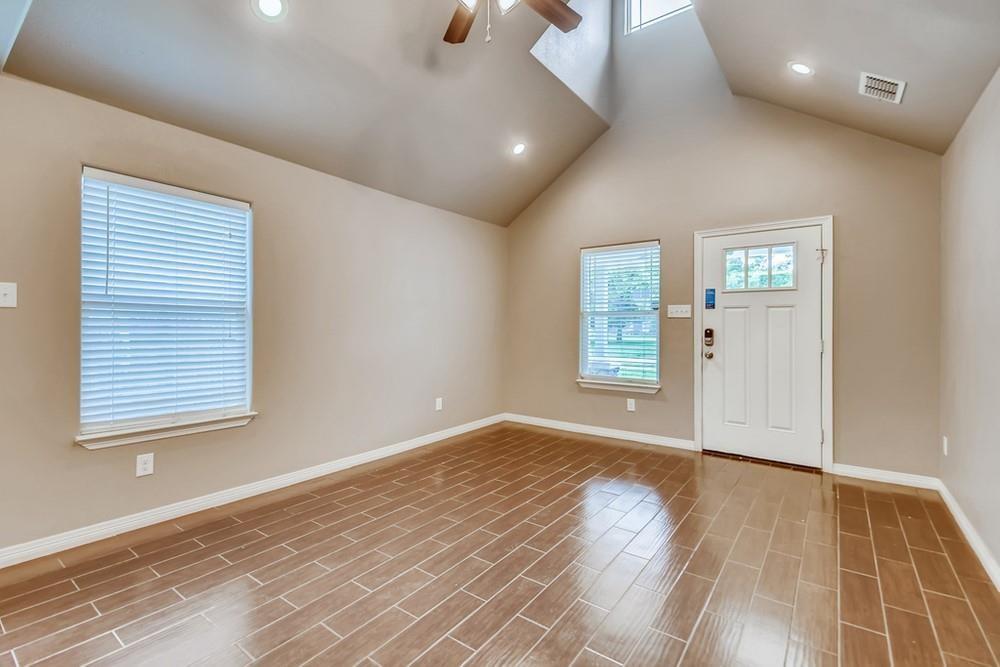 713 Rike Street McKinney, TX 75069 - Photo 5 of 29 an empty room with wooden floor and windows
