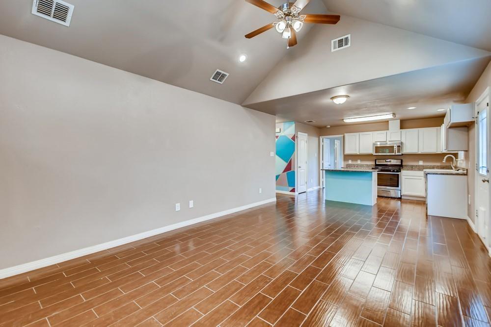 713 Rike Street McKinney, TX 75069 - Photo 6 of 29 a view of a kitchen with cabinets and wooden floor