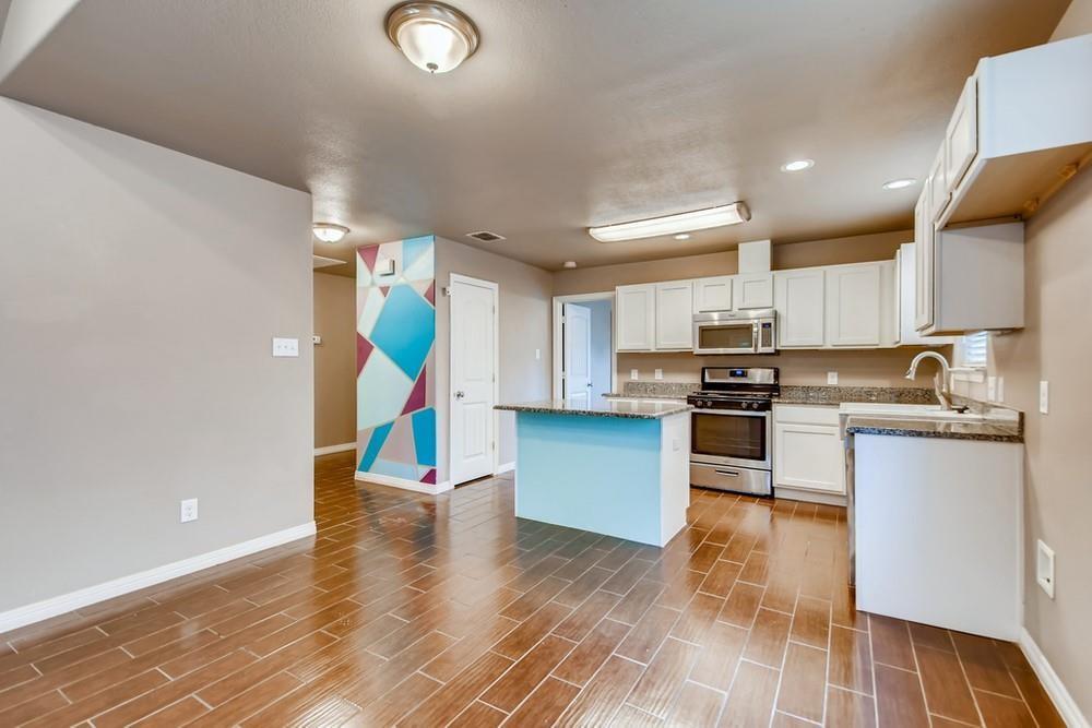 713 Rike Street McKinney, TX 75069 - Photo 7 of 29 a kitchen with stainless steel appliances granite countertop a refrigerator and a stove top oven