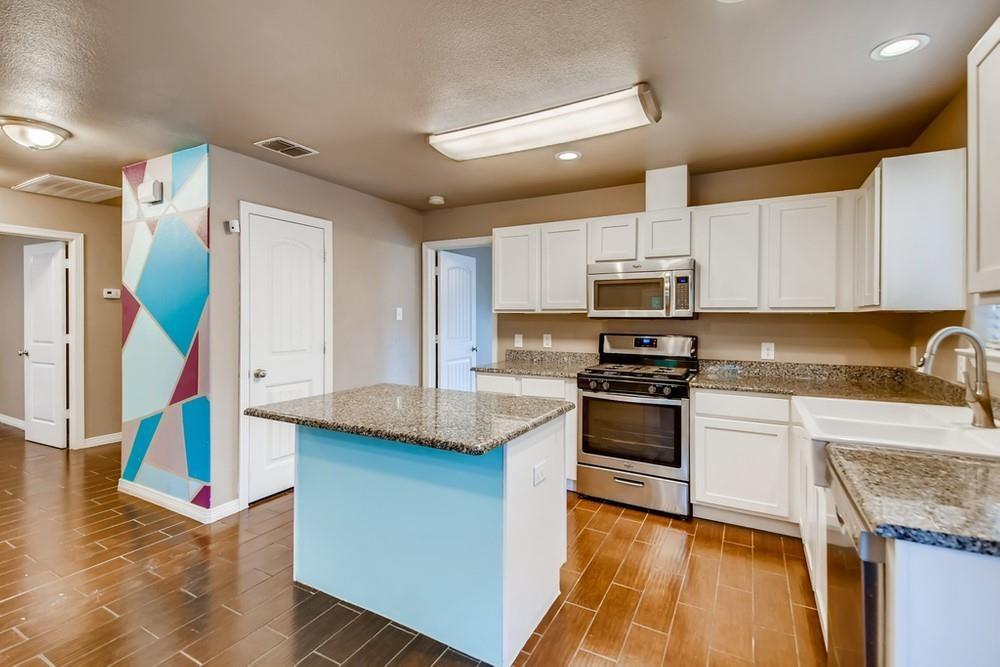 713 Rike Street McKinney, TX 75069 - Photo 9 of 29 a kitchen with stainless steel appliances granite countertop a stove a sink and a refrigerator