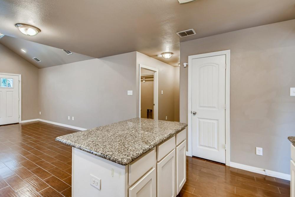 713 Rike Street McKinney, TX 75069 - Photo 10 of 29 a bathroom with a granite countertop sink and a mirror
