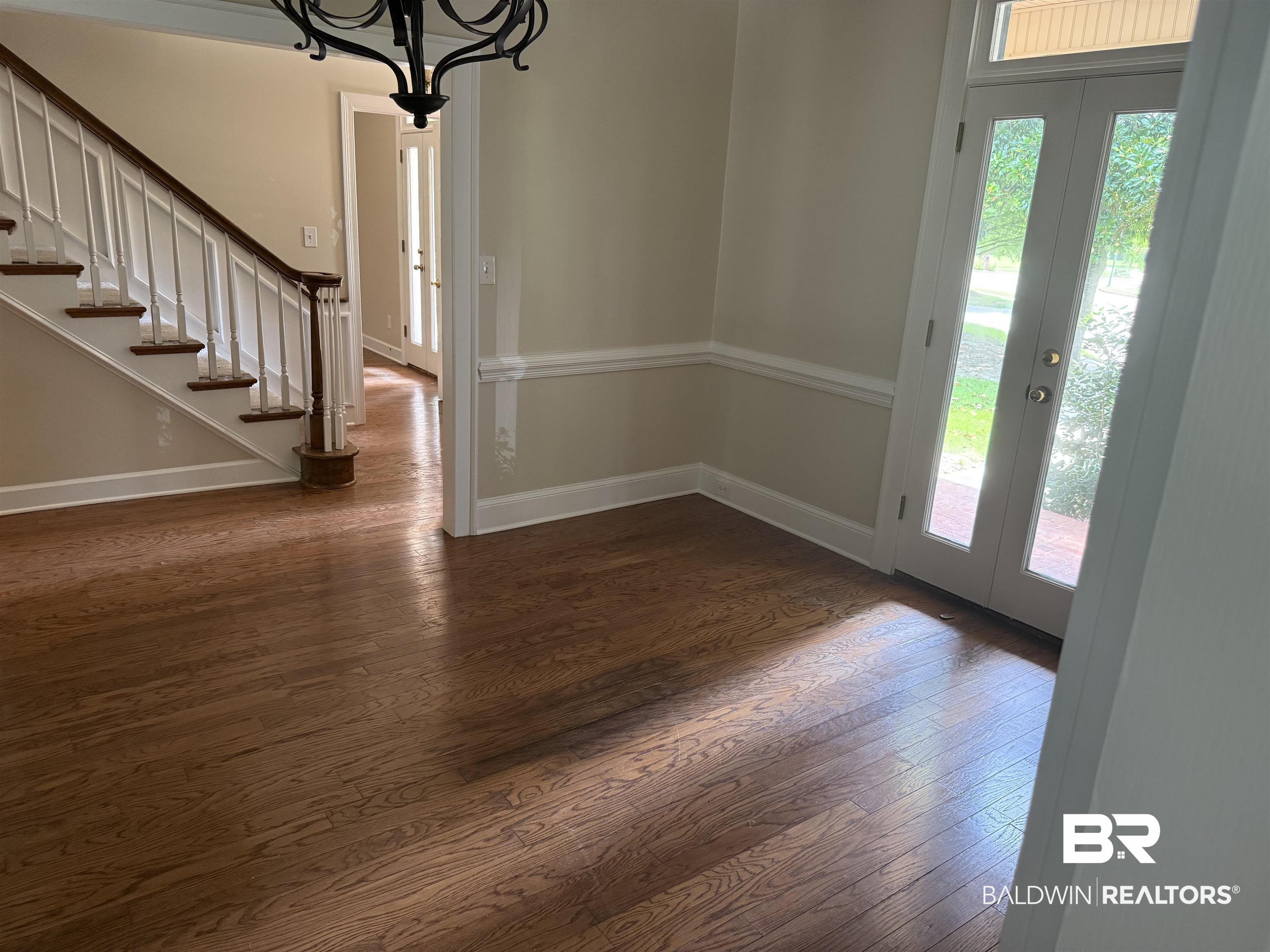 508 Barbara Court Daphne, AL 36526 - Photo 8 of 16 Foyer with french doors, healthy amount of natural light, wood finished floors, and a chandelier