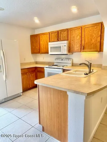 a kitchen with stainless steel appliances a sink stove and cabinets