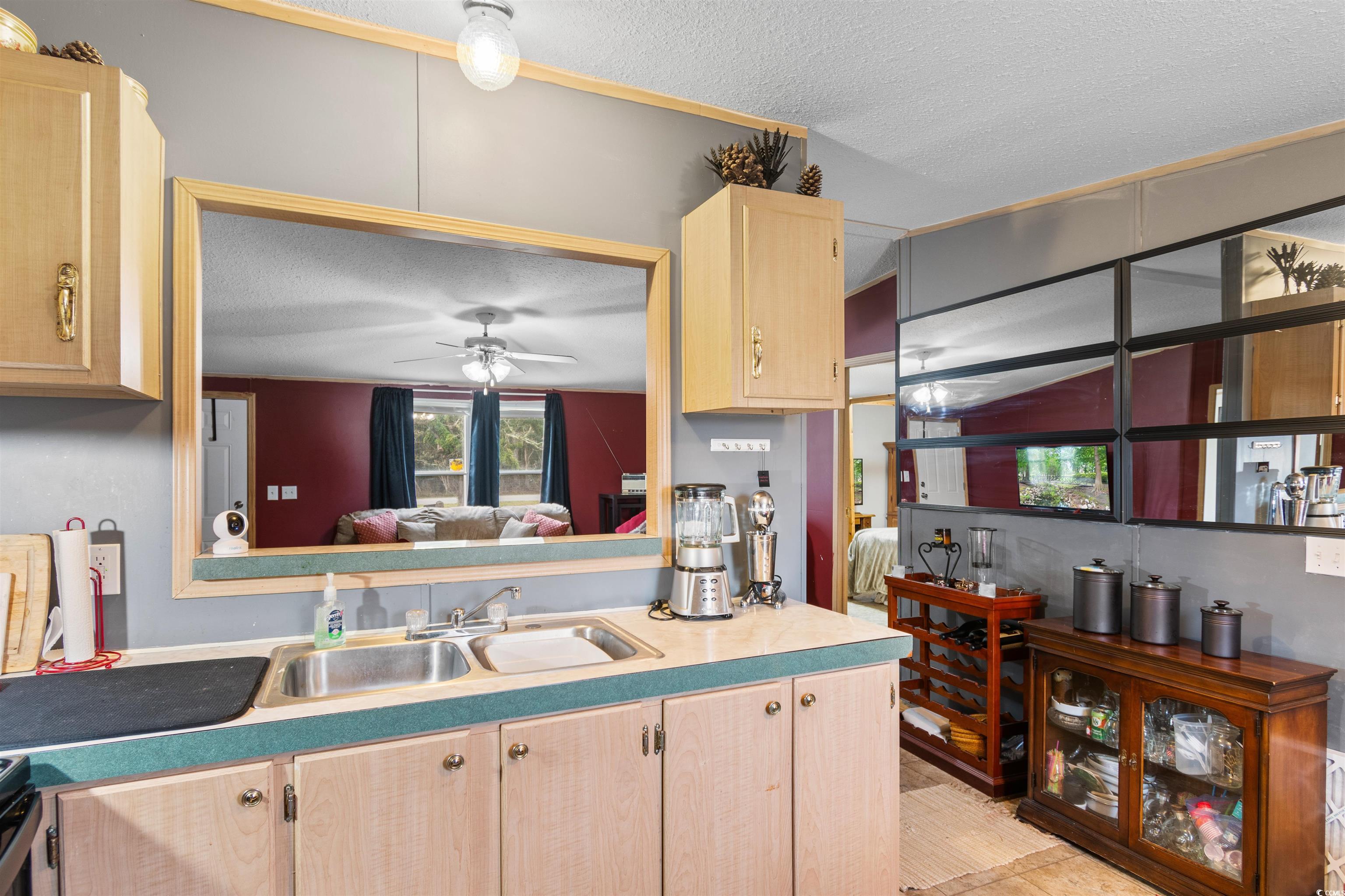 3822 Marble Road Mullins, SC 29574 - Photo 9 of 40 Kitchen with ceiling fan, sink, a textured ceiling