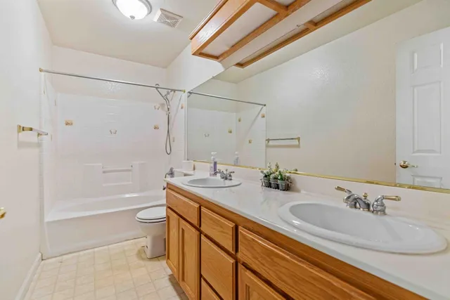 an empty room with a ceiling fan and carpet