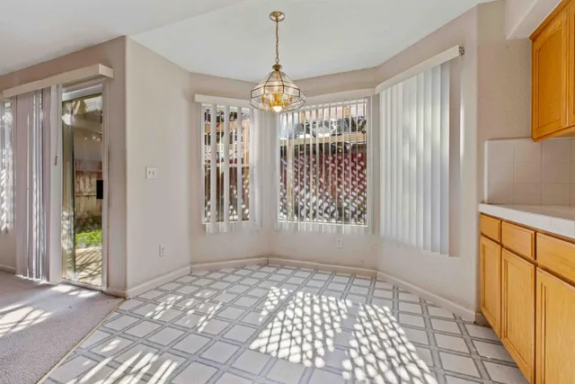 a view of a kitchen with a sink cabinet and windows