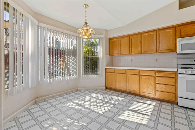 a view of a pathway of a house with wooden fence