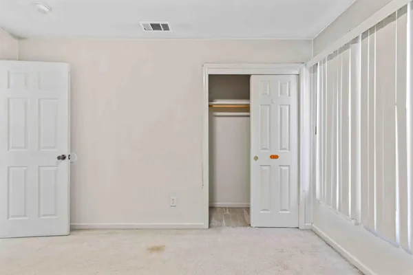 a view of a hallway with wooden shelves