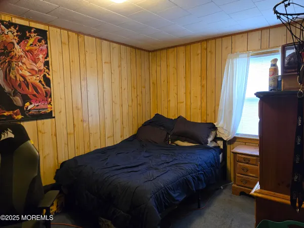 a large bed sitting in a bedroom next to a window