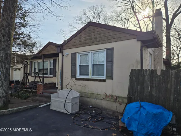 a view of house with backyard space and seating