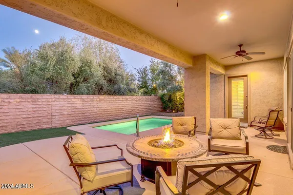 a view of a house with swimming pool and sitting area