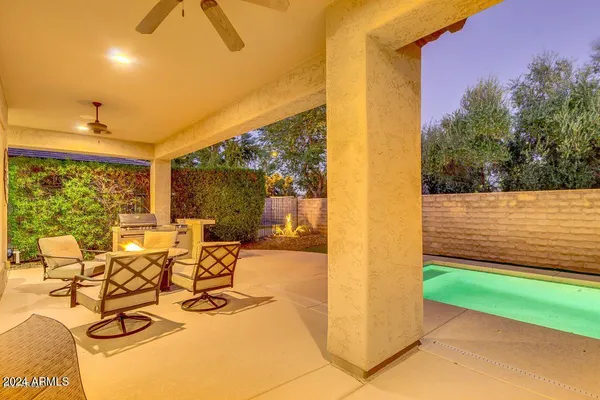 a view of a house with swimming pool and sitting area