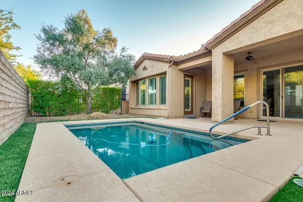 a view of a house with swimming pool and sitting area
