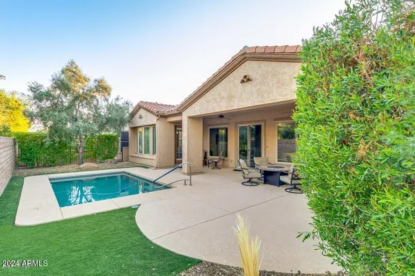 a view of a house with backyard porch and sitting area