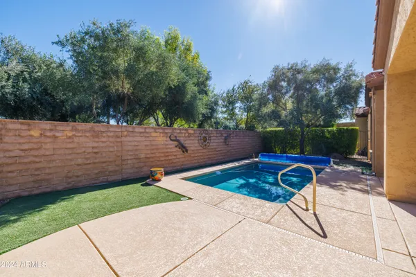 a view of a backyard with chairs and a patio