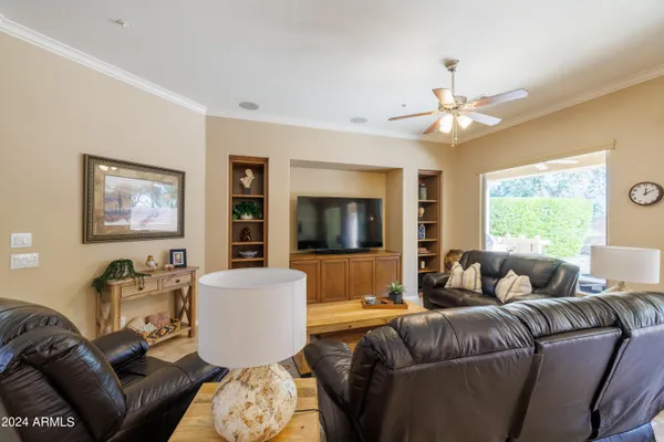a living room with furniture a window and a flat screen tv