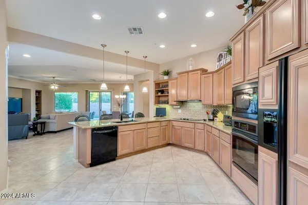 a large kitchen with a refrigerator a stove a washer and dryer