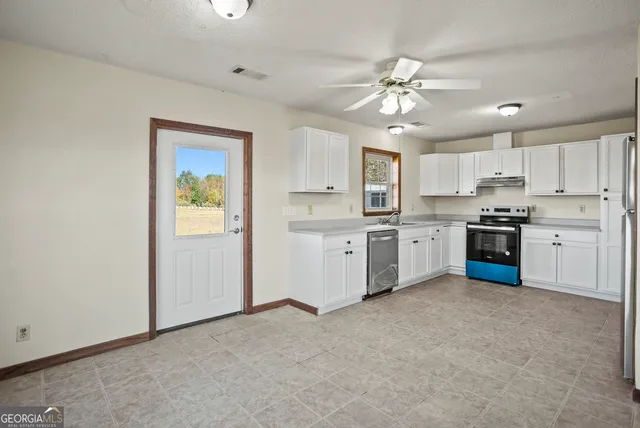 a kitchen with a stove a sink and a refrigerator