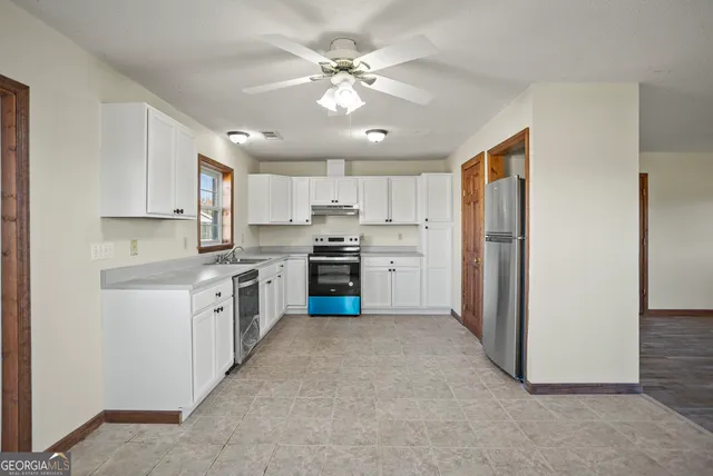 a kitchen with stainless steel appliances a refrigerator sink and cabinets