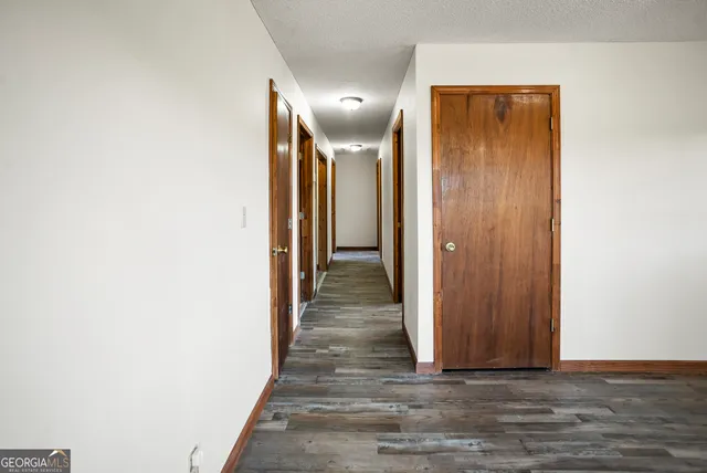 a view of a hallway with wooden floor