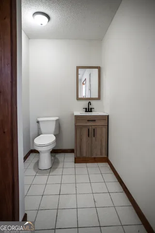 a bathroom with a sink a toilet and mirror
