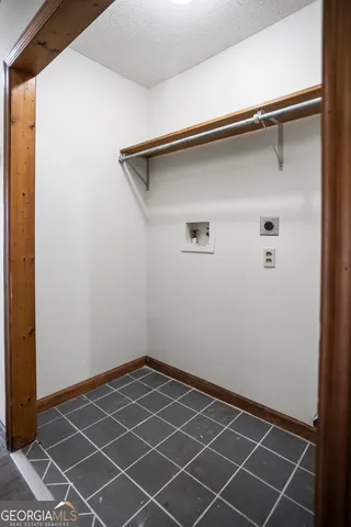 a view of a room with wooden floor and a window