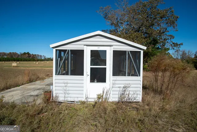 a view of house with backyard