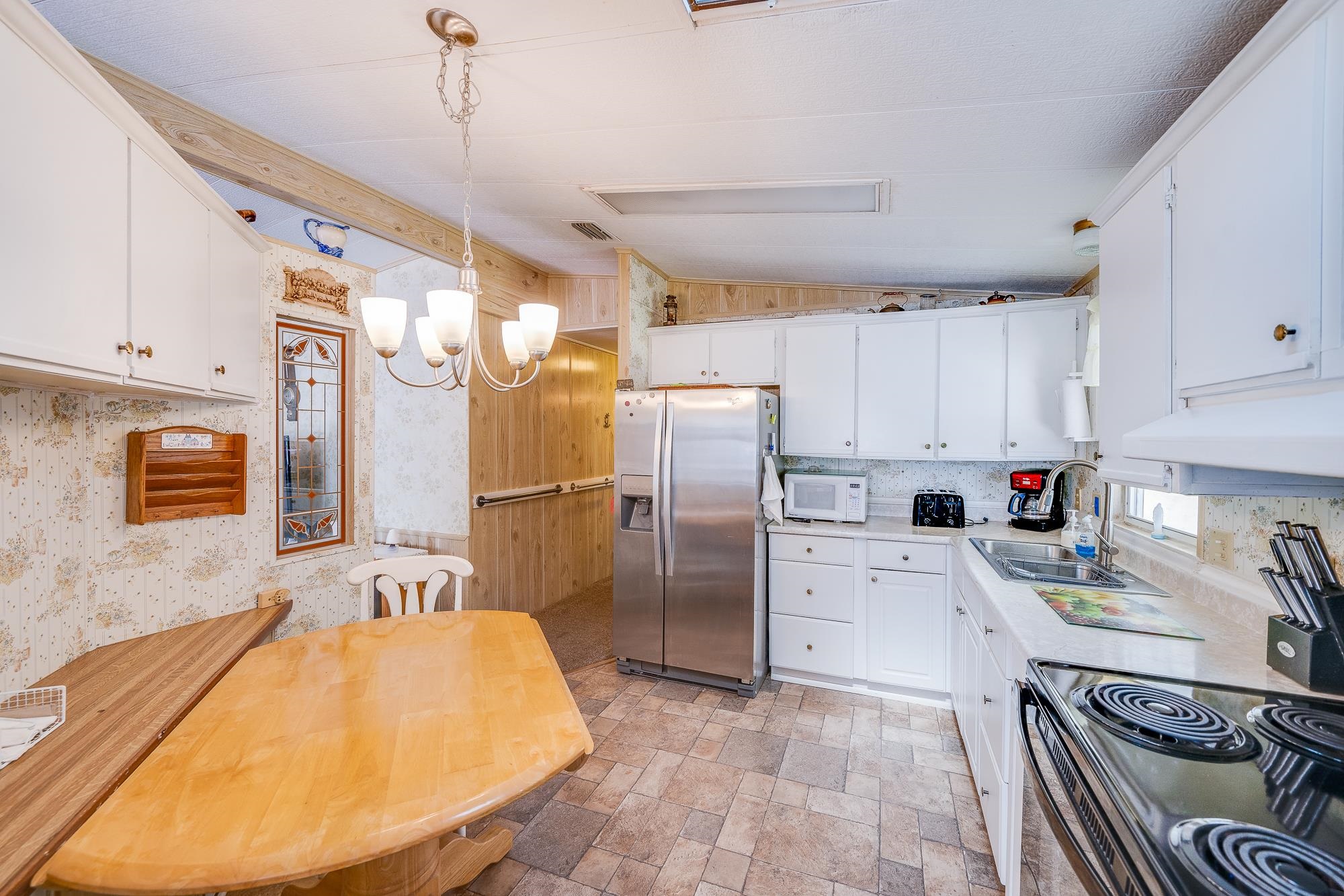 285 Pizarro Road St. Augustine, FL 32080 - Photo 22 of 47 a kitchen with stainless steel appliances granite countertop a sink refrigerator and cabinets