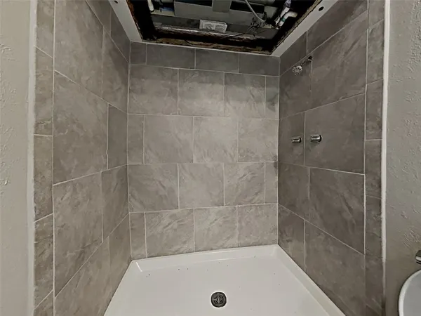 a bathroom with a shower and a bathtub