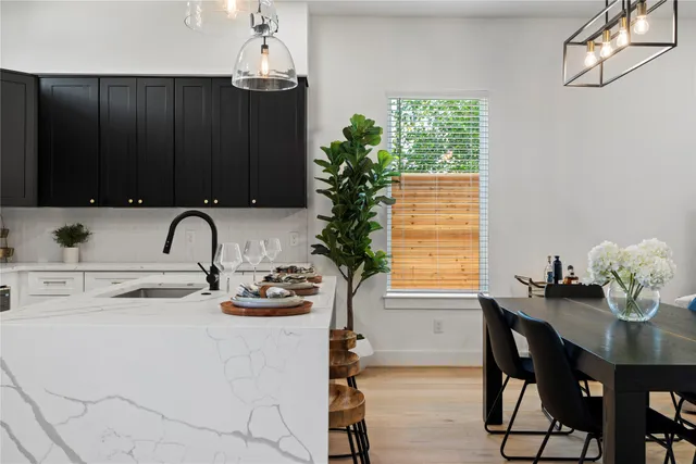 a kitchen with a sink refrigerator and microwave