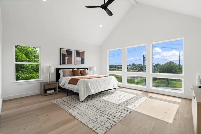 a bedroom with furniture and a large window