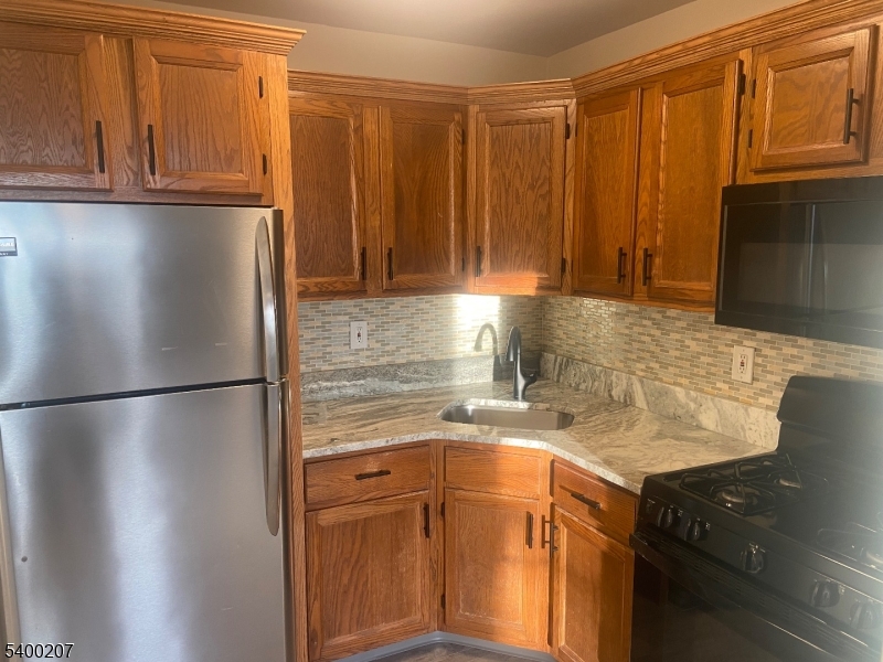 5 Terrace Drive Chatham, NJ 07928 - Photo 7 of 13 a kitchen with stainless steel appliances granite countertop a refrigerator a stove and a sink