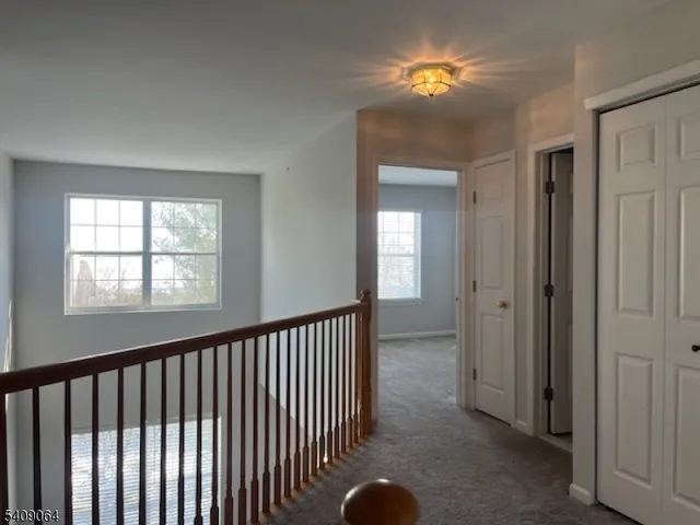 a view of empty room with a window and closet area