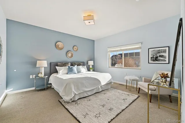 a bedroom with a bed and a lamp on table