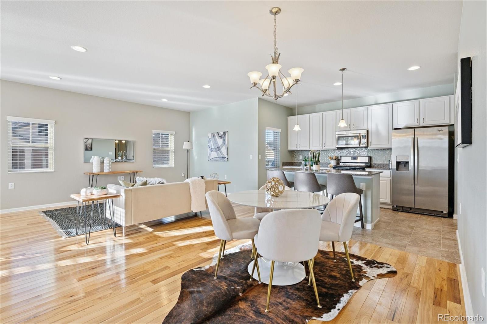 2028 South Flanders Way, Unit A Aurora, CO 80013 - Photo 2 of 25 a view of a dining room with furniture a kitchen and chandelier