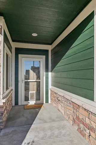 a living room with furniture a rug and a table