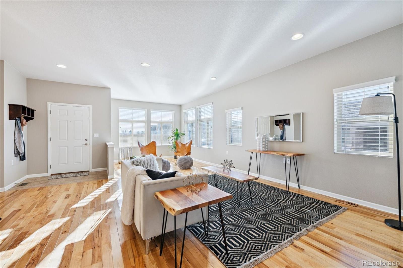 2028 South Flanders Way, Unit A Aurora, CO 80013 - Photo 3 of 25 a living room with furniture a rug and a table