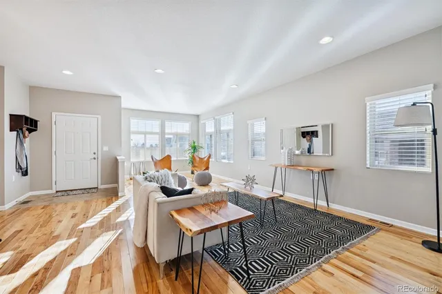 a living room with furniture dining table and a chandelier