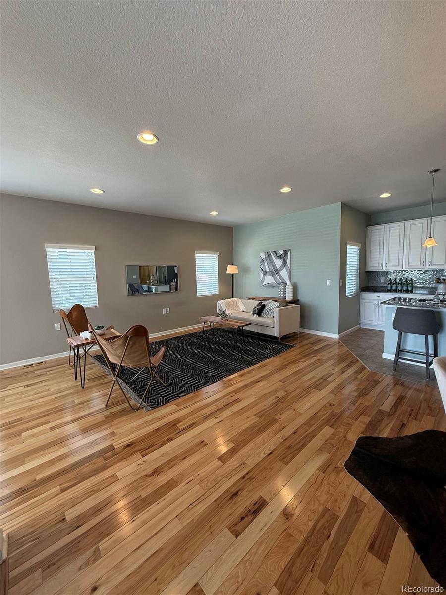 2028 South Flanders Way, Unit A Aurora, CO 80013 - Photo 6 of 30 a living room with furniture and a wooden floor