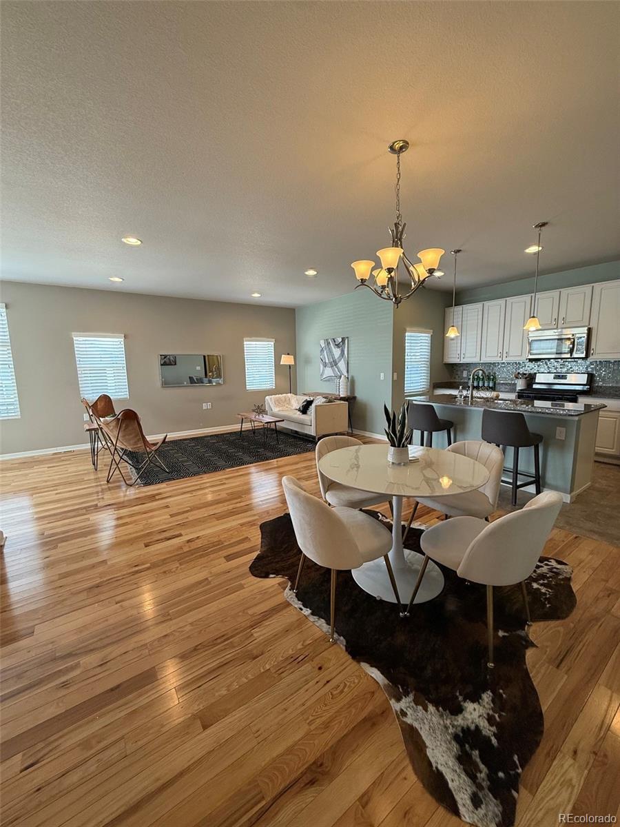 2028 South Flanders Way, Unit A Aurora, CO 80013 - Photo 8 of 30 a view of a dining room with furniture and wooden floor