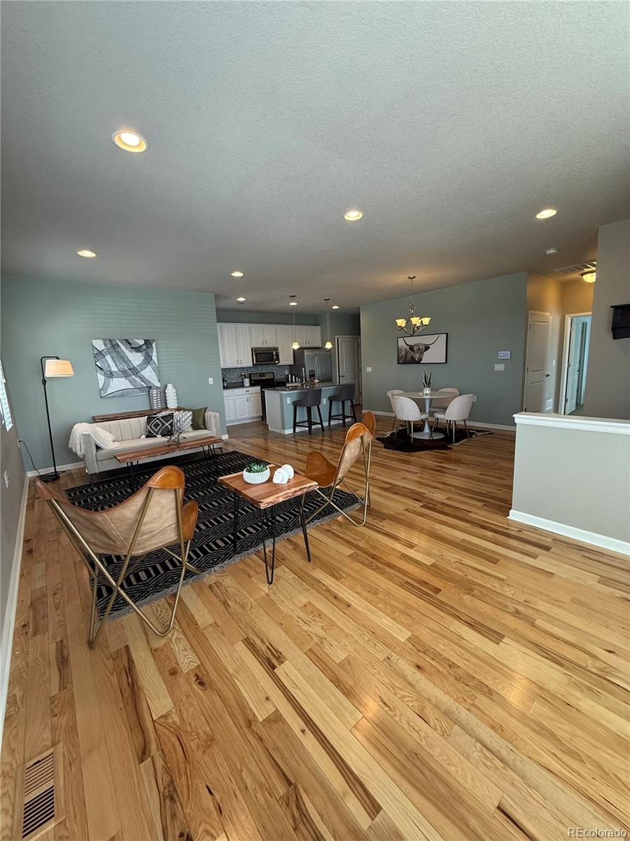 2028 South Flanders Way, Unit A Aurora, CO 80013 - Photo 9 of 30 a living room with furniture a wooden floor and next to a window