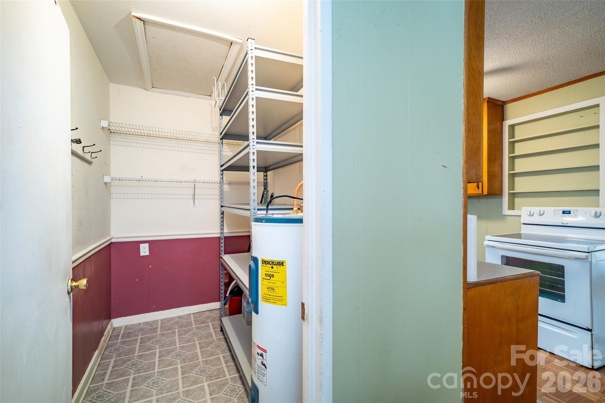 52 Miller Street Columbus, NC 28722 - Photo 7 of 22 a view of walk in closet with clothes and shoes