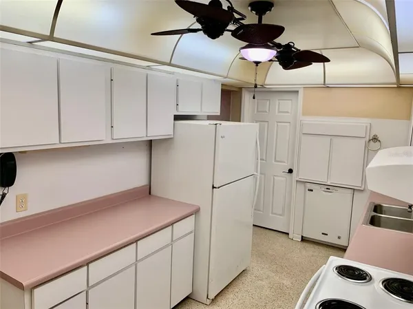 a kitchen with cabinets and appliances