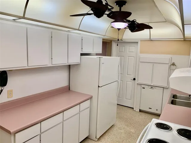 a kitchen with a stove and white cabinets