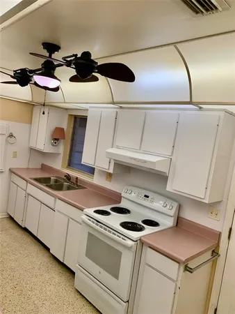 a kitchen with a stove and white cabinets