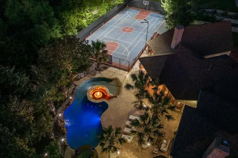 an aerial view of a house with garden space and street view
