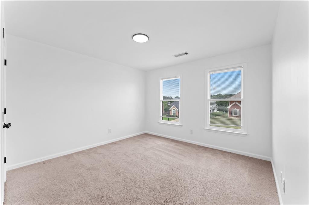 4267 Azalea Walk Ellenwood, GA 30294 - Photo 13 of 24 an empty room with windows